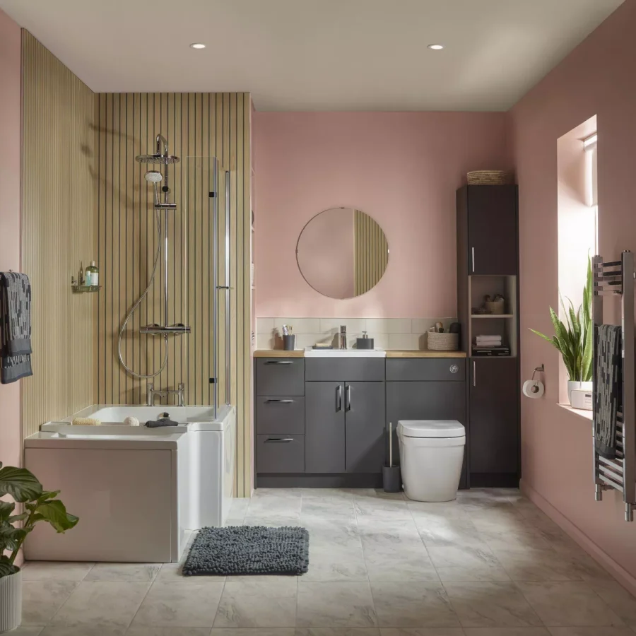 B&Q bathroom with blush walls, dark cabinets, a bath and shower