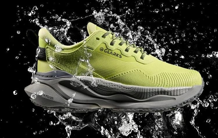 Clarks lime-green trainer splashing through water