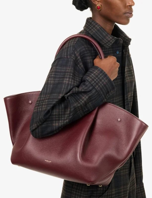 A burgundy leather tote bag featured at Selfridges