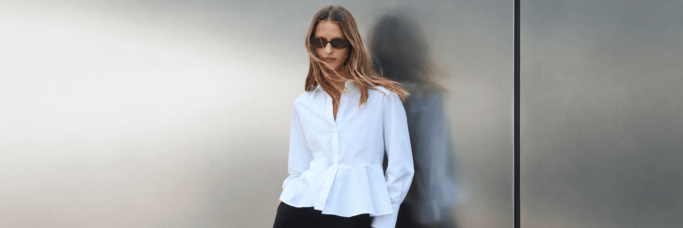 Next womenswear campaign featuring a woman in a white shirt