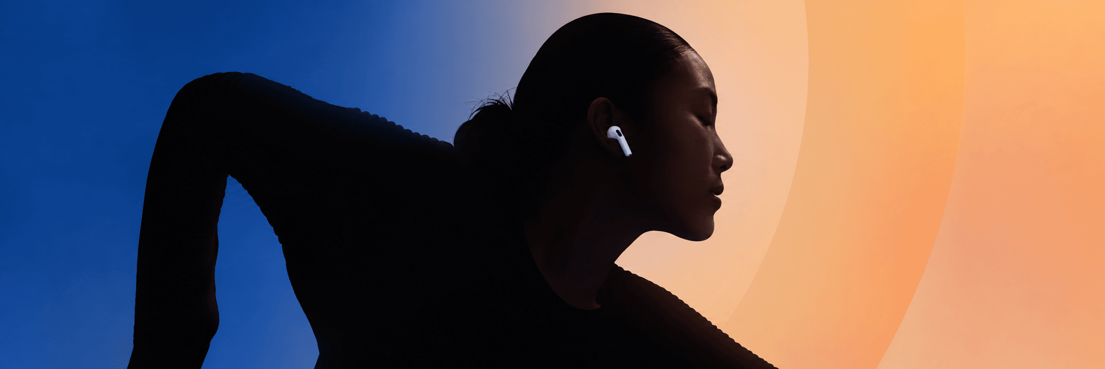 Apple AirPods worn by a runner against a blue and orange gradient
